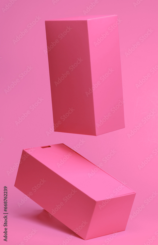 Poster two pink boxes mockup flying in antigravity on pink background with shadow. levitation object in the