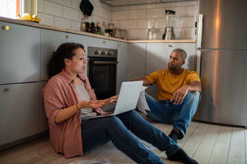 Mixed Race Couple Discussing Finances in the Kitchen
