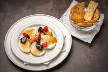 A wonderful healthy breakfast of mozzarella cheese topped with honey and fresh wild berries.