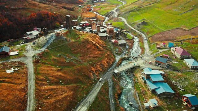 Aerial drone of the Ushguli village with Svan towers in Svaneti region in Georgia. Medieval stone tower houses with Caucasus Mountains at background, Autumn natural landscape