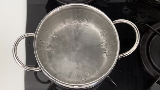 Close-up of pot with boiling water on a gas stove. cooking concept