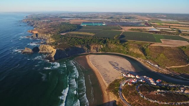 Aerial video filming by drone of the sea bay and beach near the village of Odeceixe Alentejo Portugal. Bird's eye view during sunset
