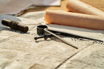 Old sailing desktop with compass measure tool, letter and historical documents