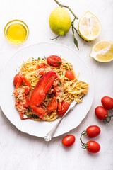 Lobster linguine pasta on the white marble table. Delicatessen, rare seafood pasta recipe....
