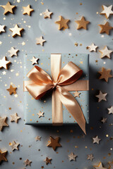Christmas gift box and golden stars with silver bow.