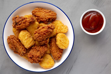 Homemade Chicken Nuggets and Chicken Wings with Ketchup, top view.
