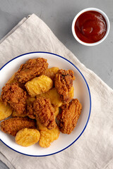 Homemade Chicken Nuggets and Chicken Wings with Ketchup, top view. Flat lay, overhead, from above.