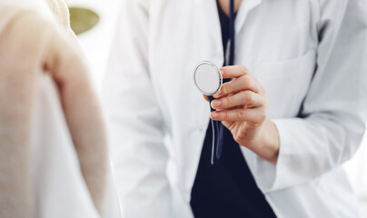 Doctor and a kid patient. Physician is holding stethoscope and ready to examine boy. Perfect health concept in medicine