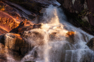 Waterfall rushing down the rocks. Sunset. Shannon Falls, Squamish, BC, Canada.