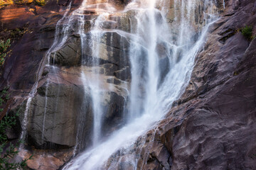 Waterfall rushing down the rocks. Sunset. Shannon Falls, Squamish, BC, Canada.