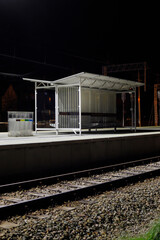 The tracks seen at night, empty platforms, dark atmosphere.