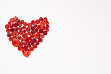 Red Plastic Buttons Arranged in the Shape of a Heart