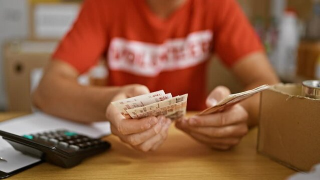 Committed young hispanic teen volunteer enthusiastically counting icelandic krona banknotes for a noble cause at a buzzing charity center