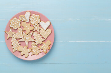 Cute homemade Christmas cookies with decor on wooden background,top view
