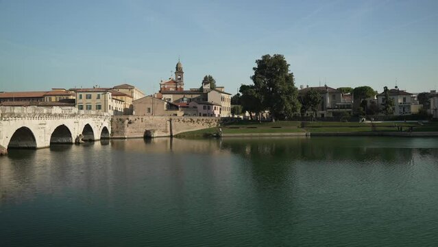 View of Ponte di Tiberio reflecting in Rimini Canal, Rimini, Emilia Romagna, Italy