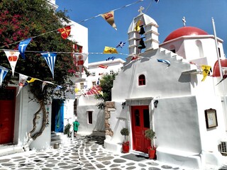 church in oia city mykonos Greece old town streets white and blue houses windmills 