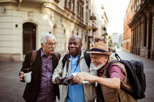 Fototapeta Senior tourists share a joyful moment on a city street