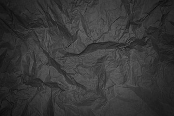 Black crumpled sheet of paper with vignetting