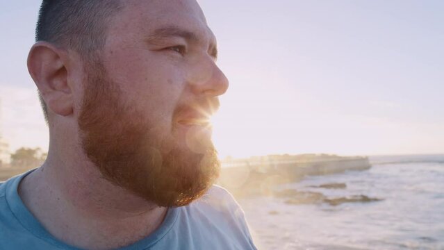 Runner man, beach and plus size for exercise, workout or breathing fresh air for health, rest or relax. Sunshine, ocean running and weight loss training in summer for healthcare, thinking or fitness