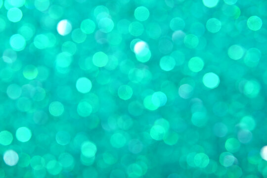 Abstract background of teal bokeh lights