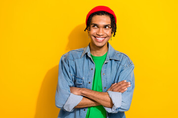 Photo of cheerful tricky man wear stylish clothes looking empty space idea plan isolated on vivid yellow color background