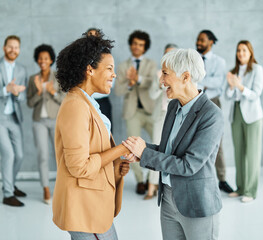 young business people meeting office handshake hand shake shaking hands teamwork group contract agreement black happy smiling success partnership introduction greeting businesswoman mature black  - obrazy, fototapety, plakaty
