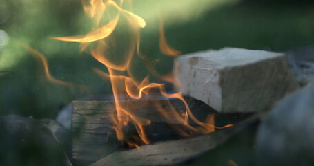Wood Chunk Igniting Small Campfire in Ultra Slow-Motion, Fueling Bonfire with Timber, Sparks and...
