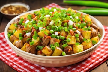 barbecue potato salad topped with chopped green onions