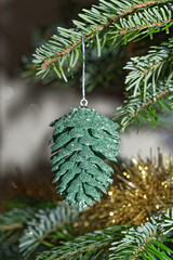 Green cone hanging on christmas tree - 668842802