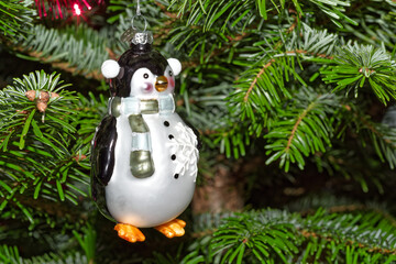 Penguin hanging on Christmas tree as decoration - 668842814