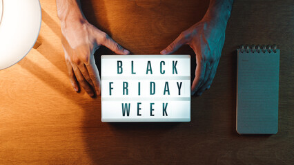 Holding Black Friday week sign - obrazy, fototapety, plakaty