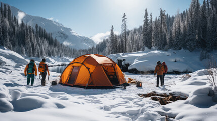 Camping in the mountains in winter. Tourists stand near the tent.