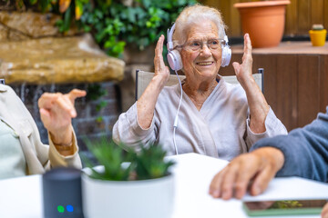 Happy seniors listening to his favorite music in a geriatric