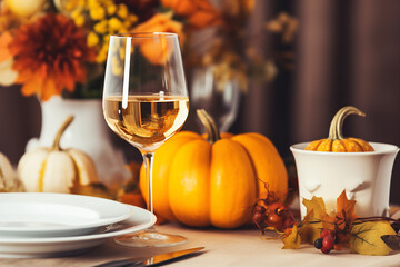 Thanksgiving Table Setting with Autumnal Decorations, Pumpkins, Glasses and Plates - Created with generative AI tools