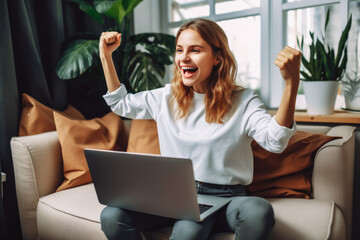 Fototapeta na wymiar Beautiful young scandinavian woman smiling and rejoices after success. Happy woman celebrating business success on sofa in living room with computer.