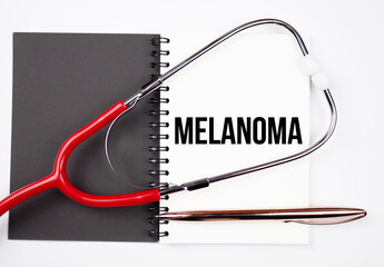 Melanoma, text inscription on a notepad with a stethoscope. MELANOMA, medical concept.