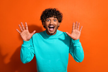 Photo of overjoyed astonished person raise arm open mouth unexpected offer sale isolated on orange color background