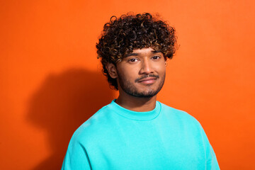 Fototapeta premium Photo of positive cool young person nice wavy hairstyle empty space ad blank isolated on orange color background