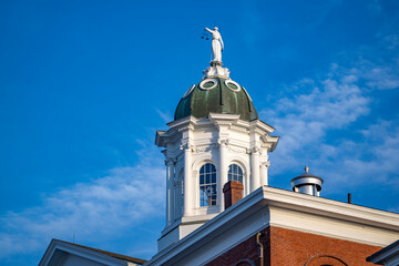 Themis with scales in her hand on the dome of a building in New England
