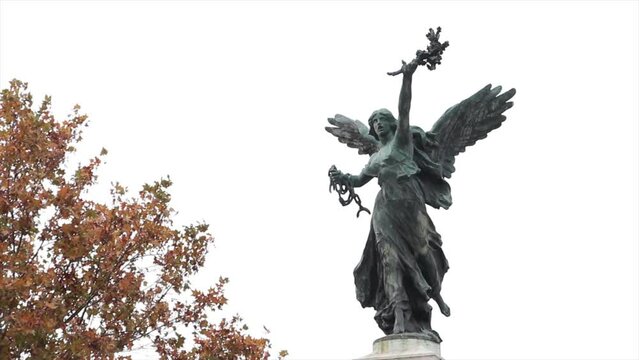 bronze angel statue rome italy with tree