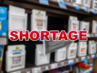 Blurred background of various baby formulas for sale with the red text Shortage in the foreground