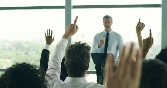 Business man, leader and raised hand at conference for question, answer or idea for problem solving. CEO, boss or presenter with faq, group or audience for talking, planning or brainstorming in crowd