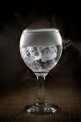 Glass with soda and ice with smoke effect.