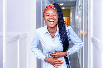 Joyful Woman Holding Her Stomach and Smiling