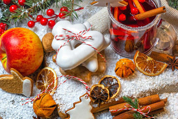 Top view of a cup of mulled wine, Christmas cookies, fruit and spices, closeup. Christmas...