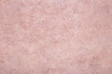 Abstract background of concrete stone pink wall. The texture of the stone surface. Old worn out wall