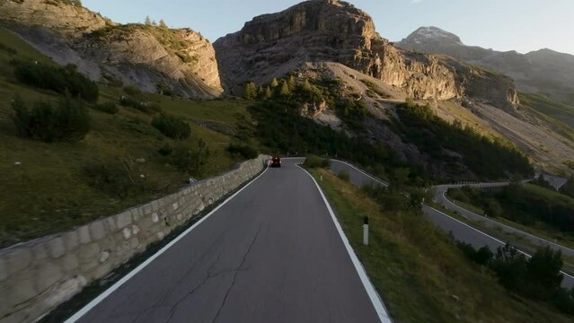 areal footage of following car going hill sunny summer day in high alp mountains epic view and drive 