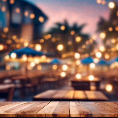 Empty wooden table and abstract blurred background of cafe with bokeh light. Wooden table with blur beach cafes background and bokeh lights created.  - obrazy, fototapety, plakaty