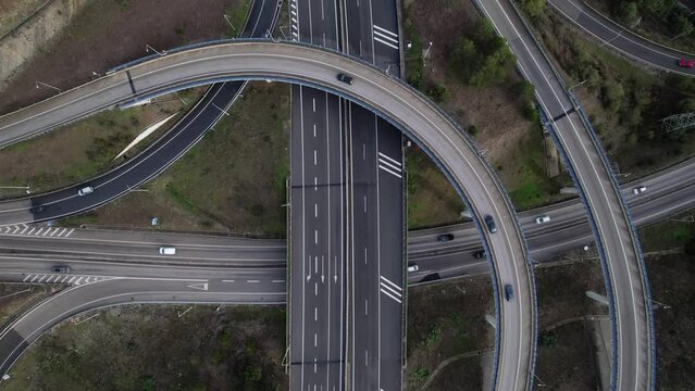 Aerial drone top down view of a spaghetti junction highway at rush hour