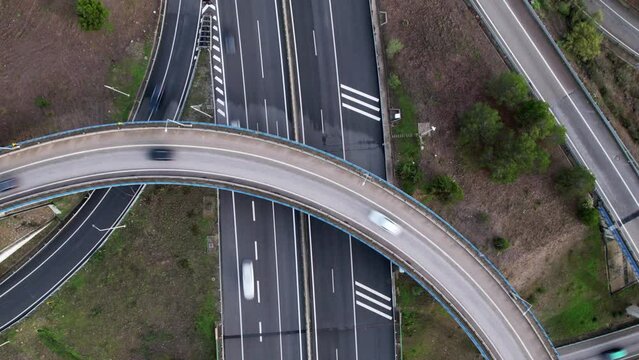 Aerial drone top down hyperlapse view of a spaghetti junction highway at rush hour